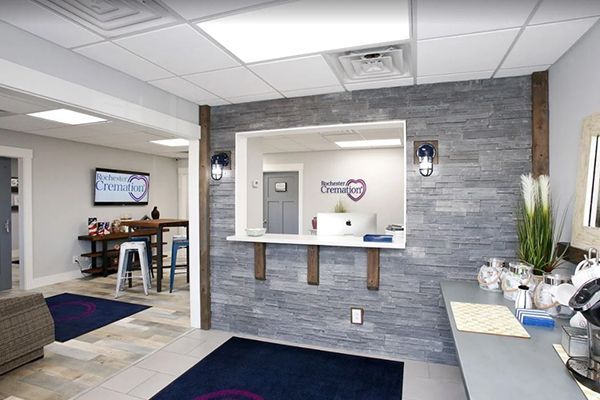 Reception area with gray stone accent wall, desk, and waiting area.