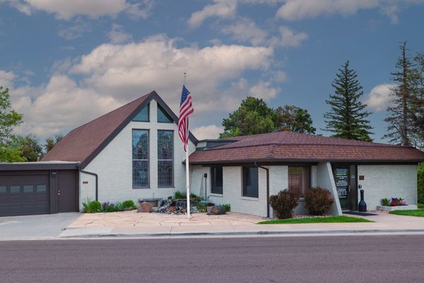 Church building with an American flag in front.