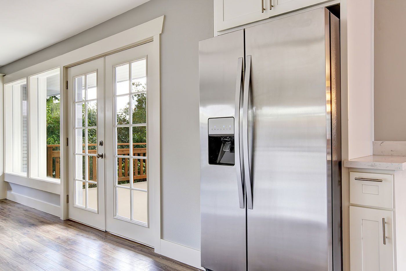 Bright kitchen room with steel appliances and granite tops