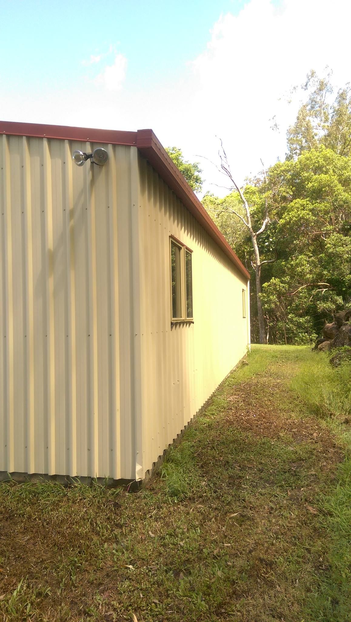 A Man is Using a High Pressure Washer to Clean the Sidewalk — Blast H2O In Proserpine, QLD