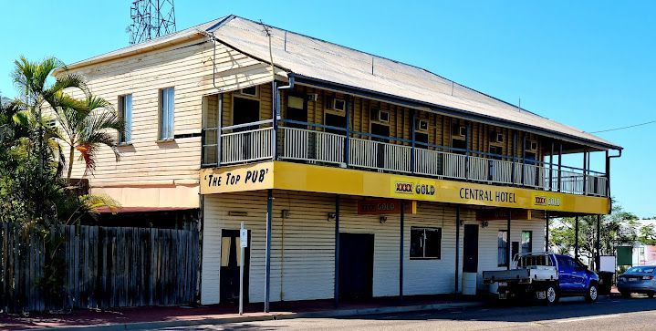A Large White Building With a Yellow Awning That Says ' Motel ' on It — Blast H2O In Collinsville, QLD