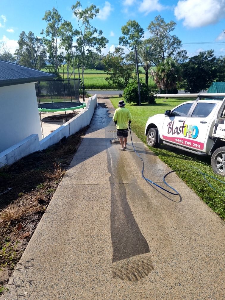 A Person is Cleaning a Wooden Table With a High Pressure Washer — Blast H2O In Cannonvale, QLD