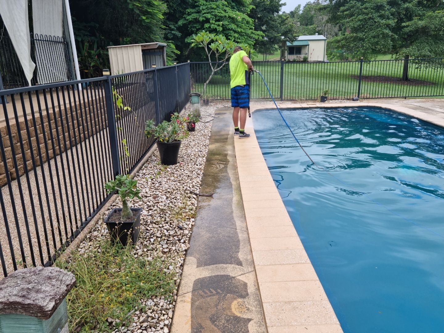 A Person is Cleaning a Tennis Court With a Hose — Blast H2O In Cannonvale, QLD
