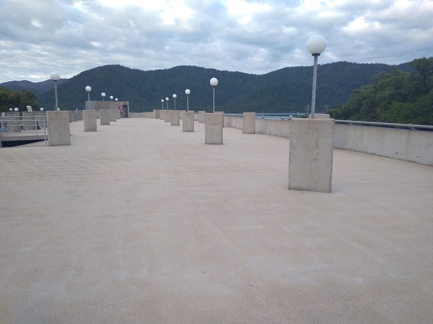 A Man is Using a High Pressure Washer to Clean a Sidewalk — Blast H2O In Airlie Beach, QLD