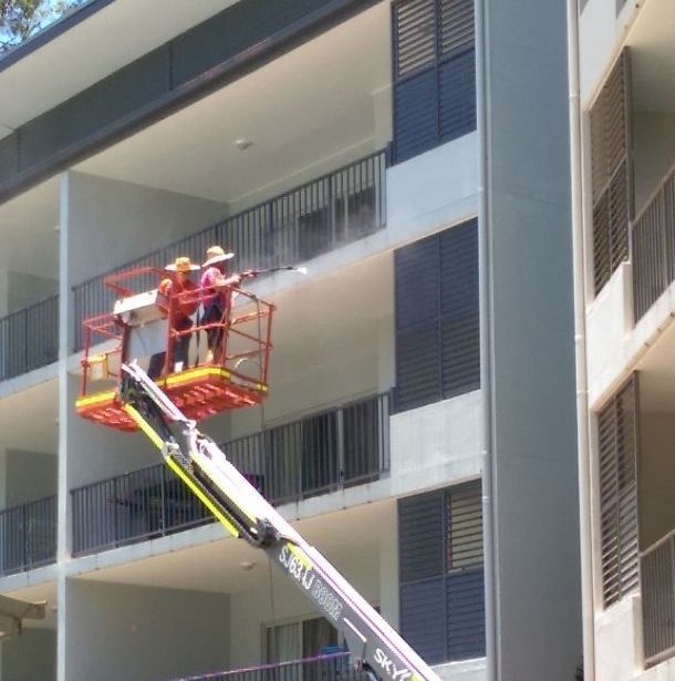 A Person is Using a High Pressure Washer to Clean a Concrete Floor — Blast H2O In Proserpine, QLD