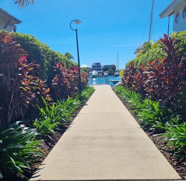 A Man is Using a High Pressure Washer to Clean the Sidewalk — Blast H2O In Proserpine, QLD