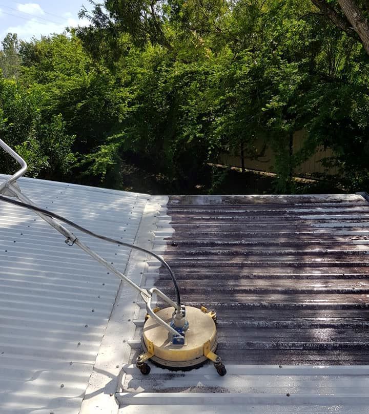 A Roof is Being Cleaned With a Machine — Blast H2O In Proserpine, QLD