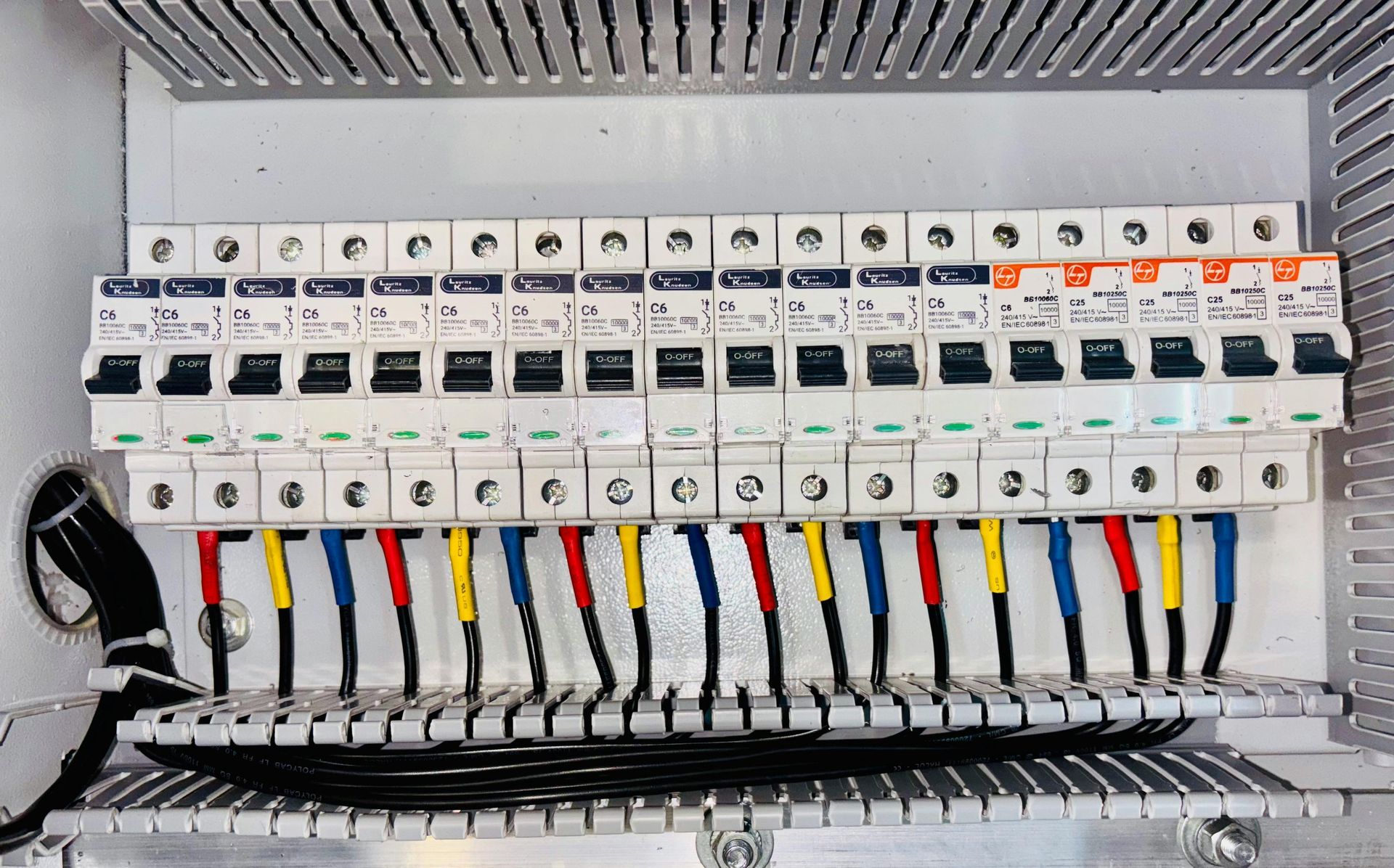 A close up of a electrical box with a bunch of wires coming out of it.