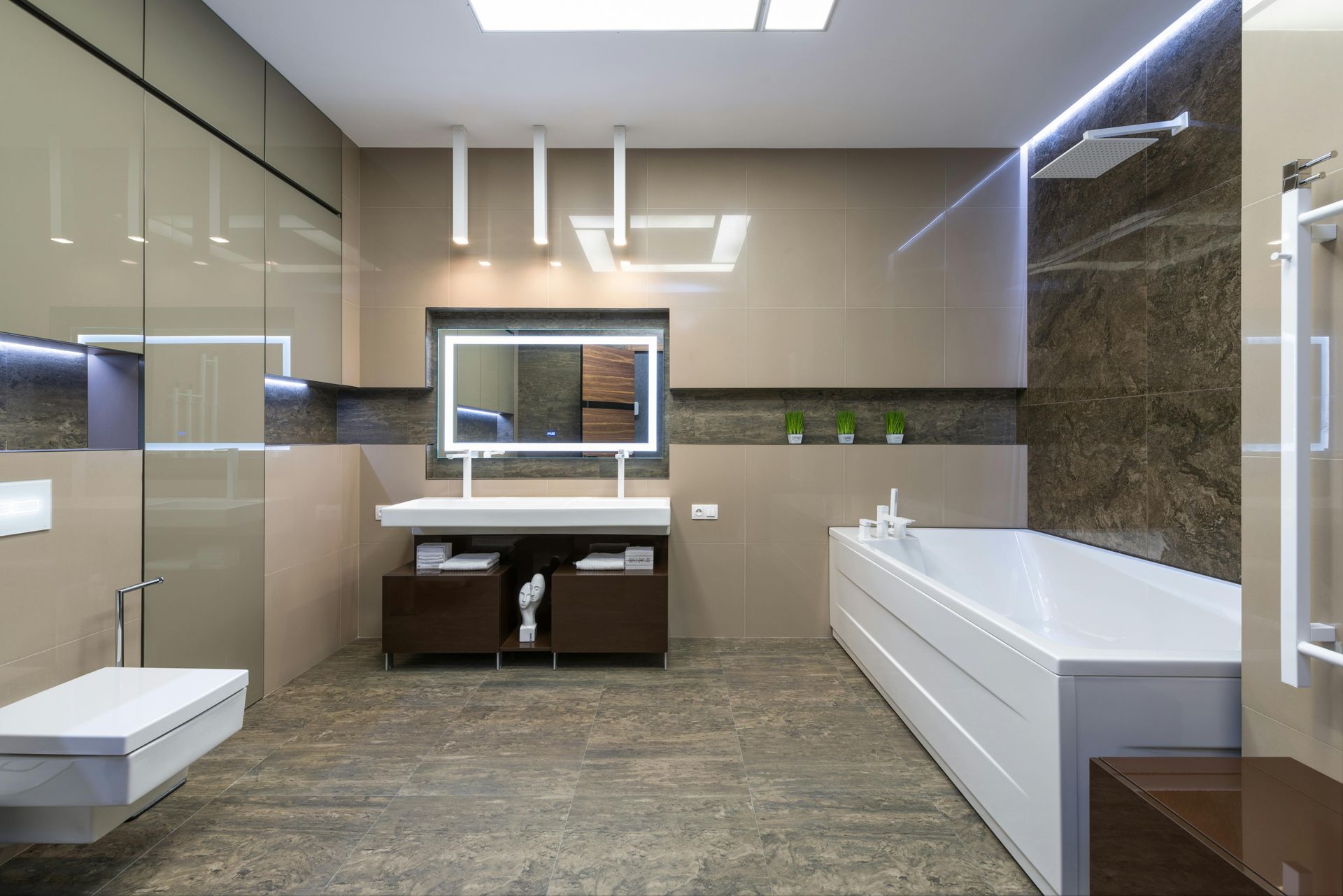 A bathroom with a bathtub , sink , toilet and mirror.