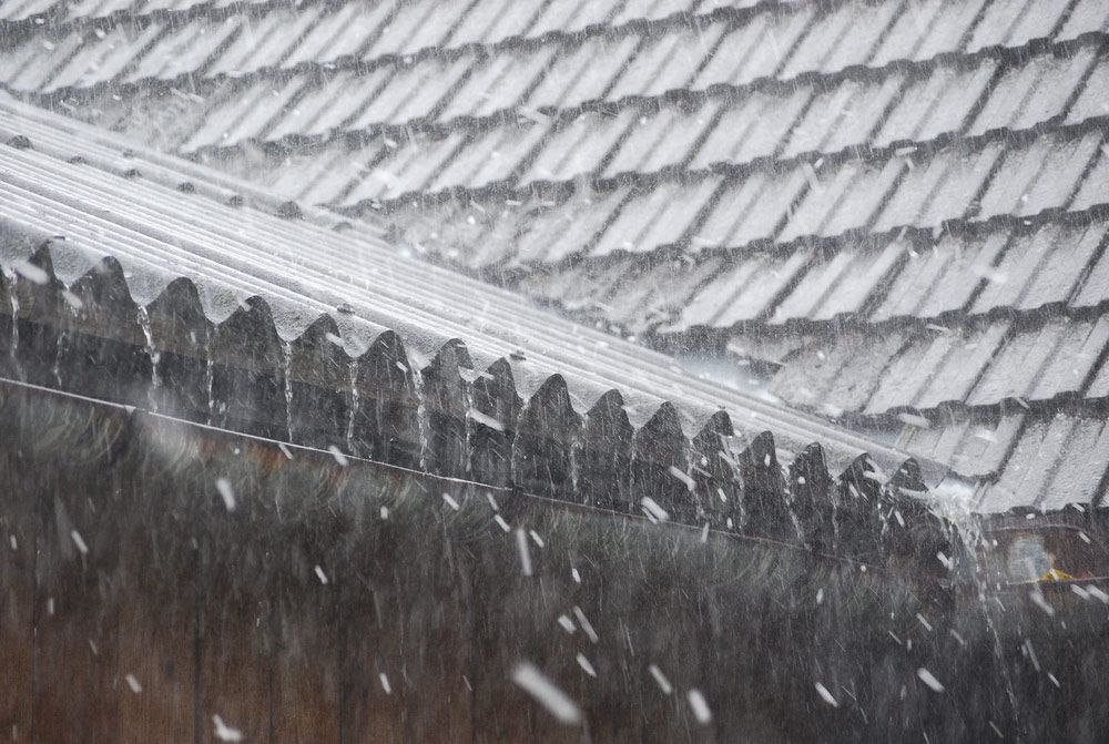 A Close Up of a Roof With Snow Falling on It — East Coast Roof Tiling Services in Kuluin, QLD