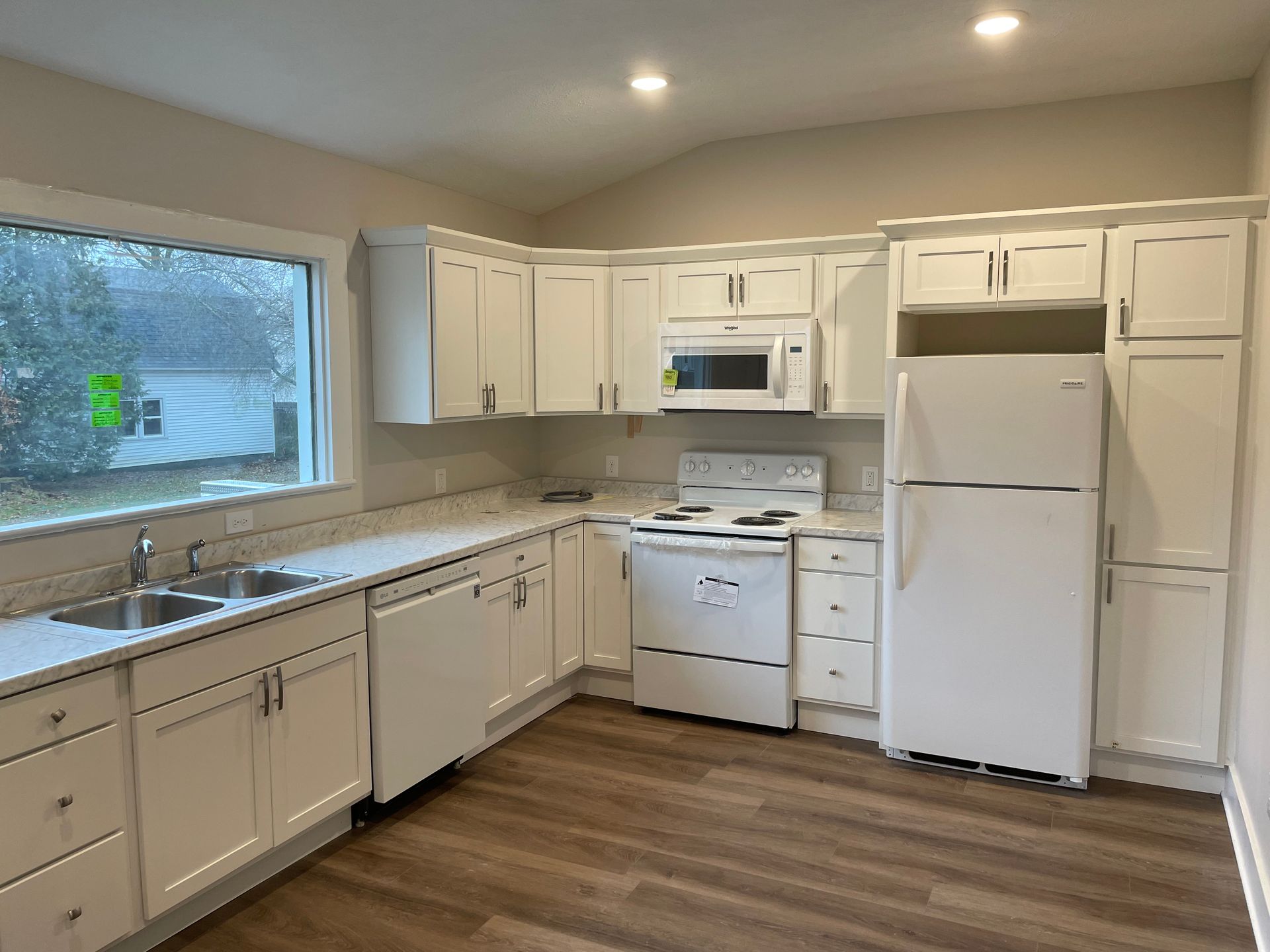Living room with a sliding glass door to a deck, a fireplace, and a sectional sofa.