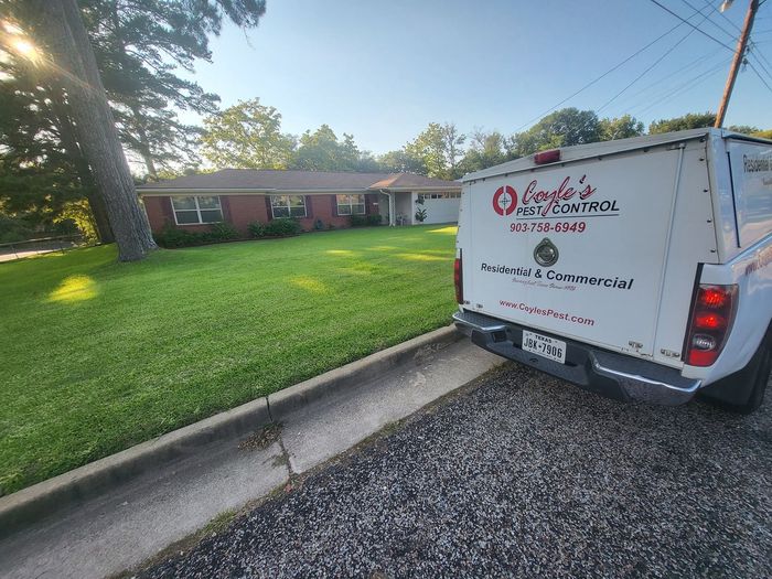 A white truck is parked in front of a house.