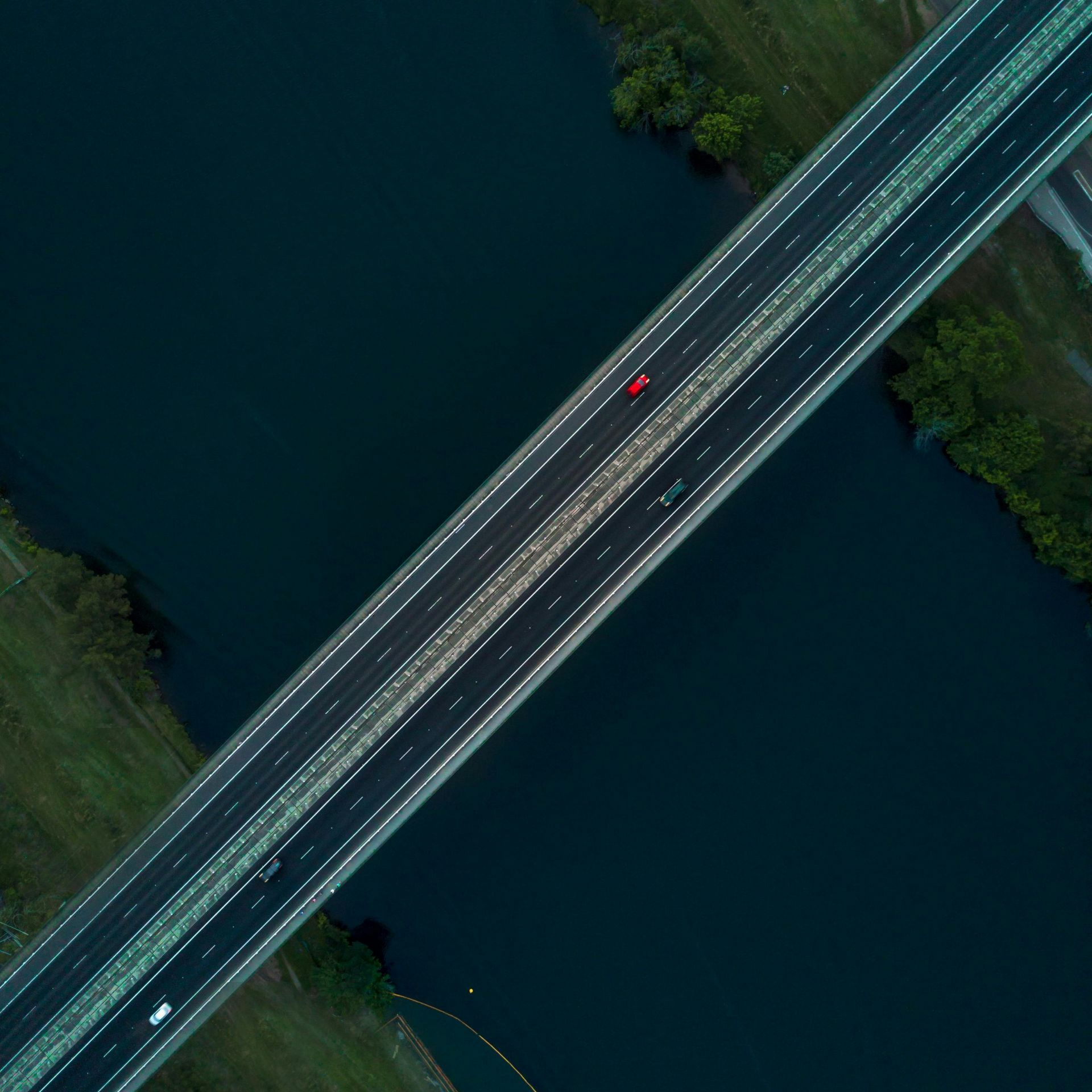 A specialist recruiter in a suit is smiling and holding a clipboard