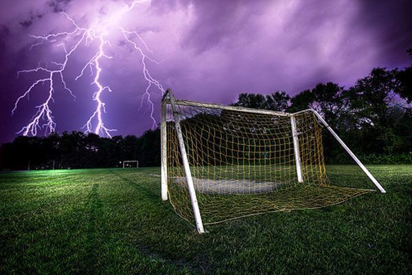 Soccer goal with lightning in the background