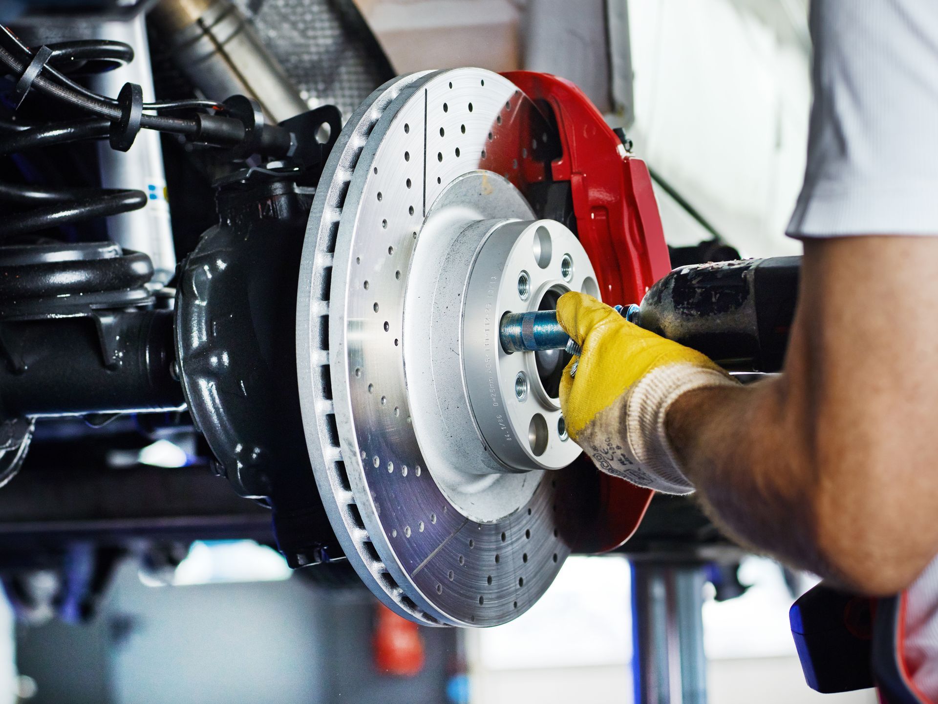 Mechanic working on brake disc | Laires and Son Auto