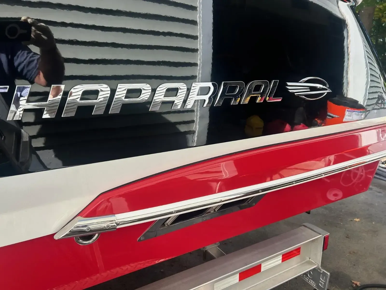 A red and white boat with the word haparral on it