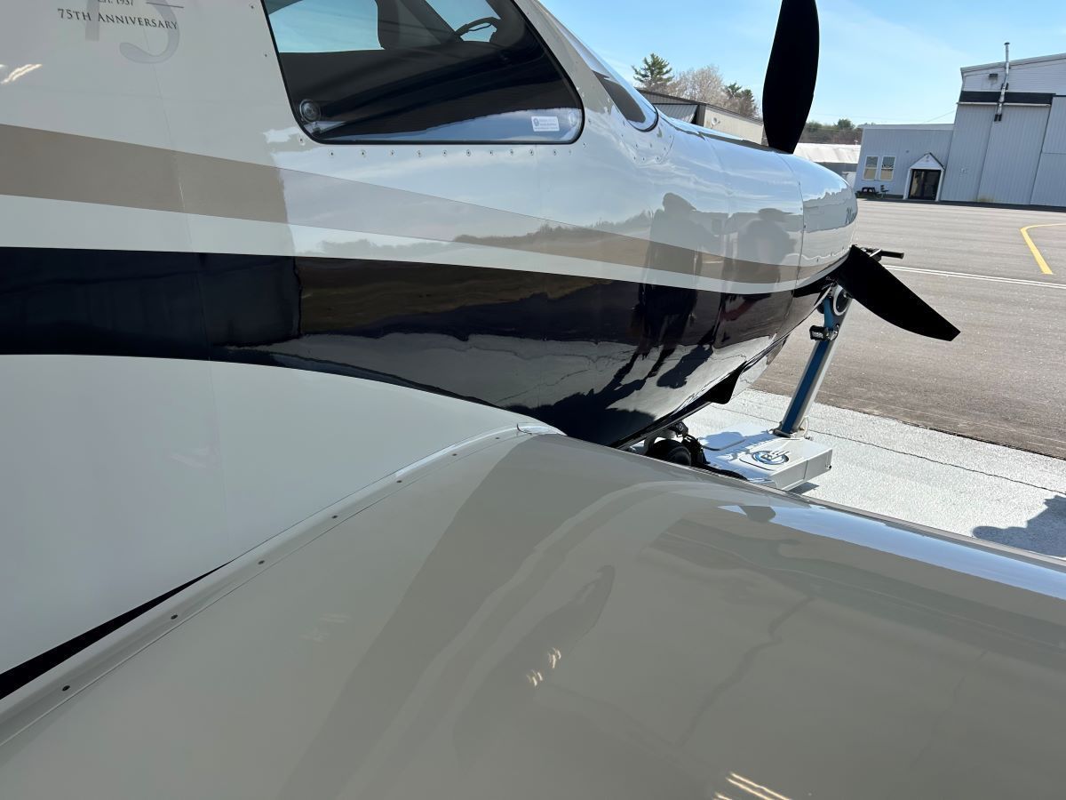 A small plane is parked on the side of the road