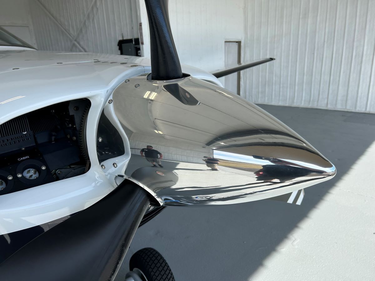 A close up of a silver propeller on a plane