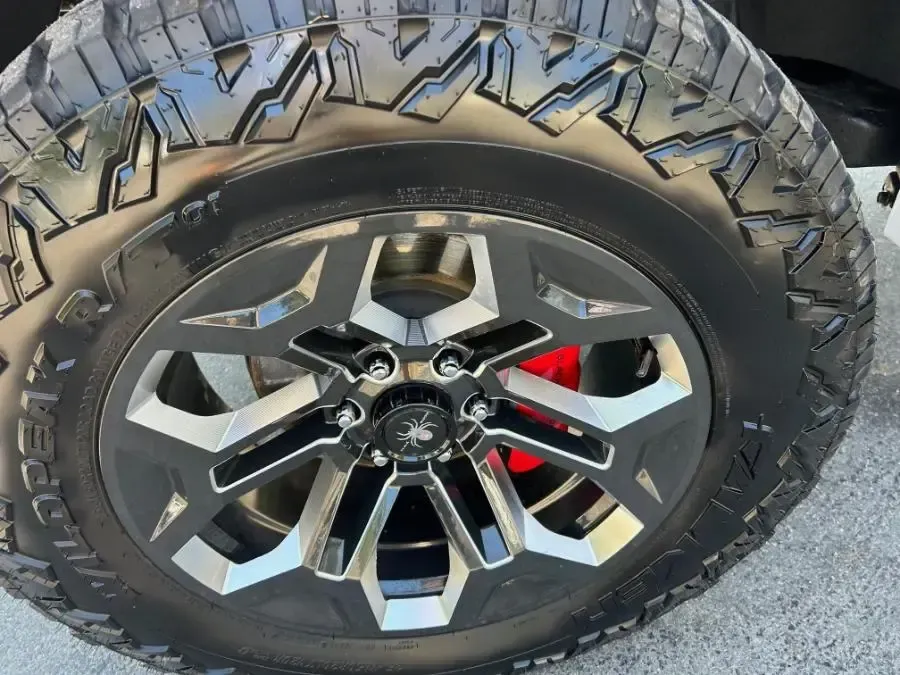 A close up of a tire with a red rim
