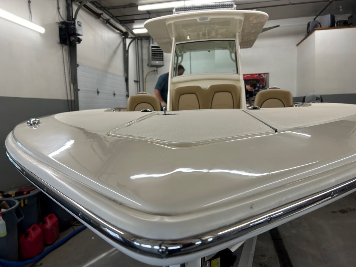A man is working on a boat in a garage