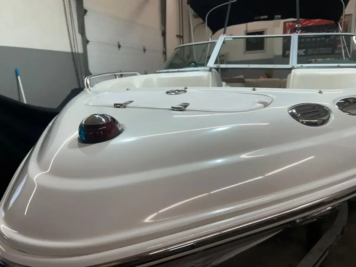 White boat bow with navigation light and chrome details.