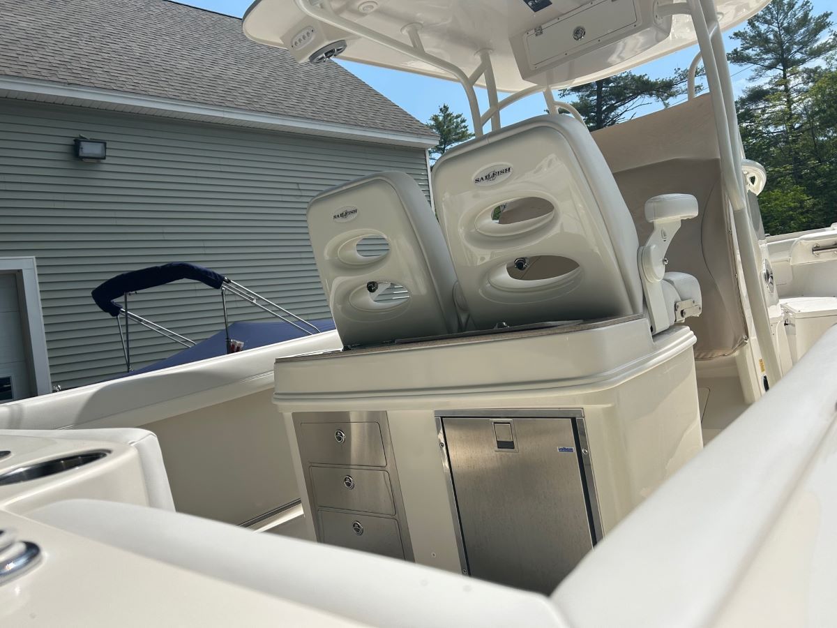 A white boat with two speakers on top of it