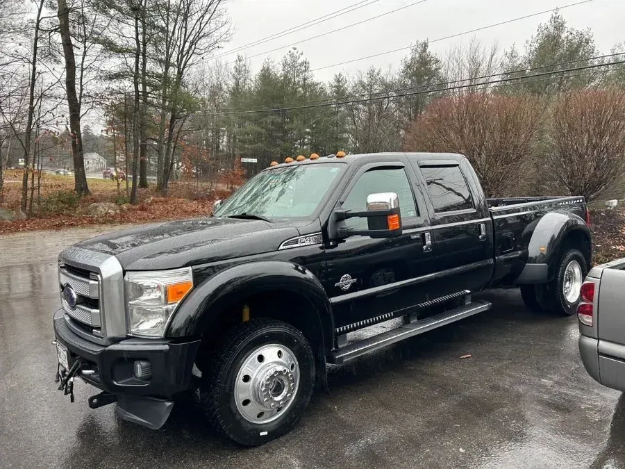 A black pickup truck is parked in a parking lot.
