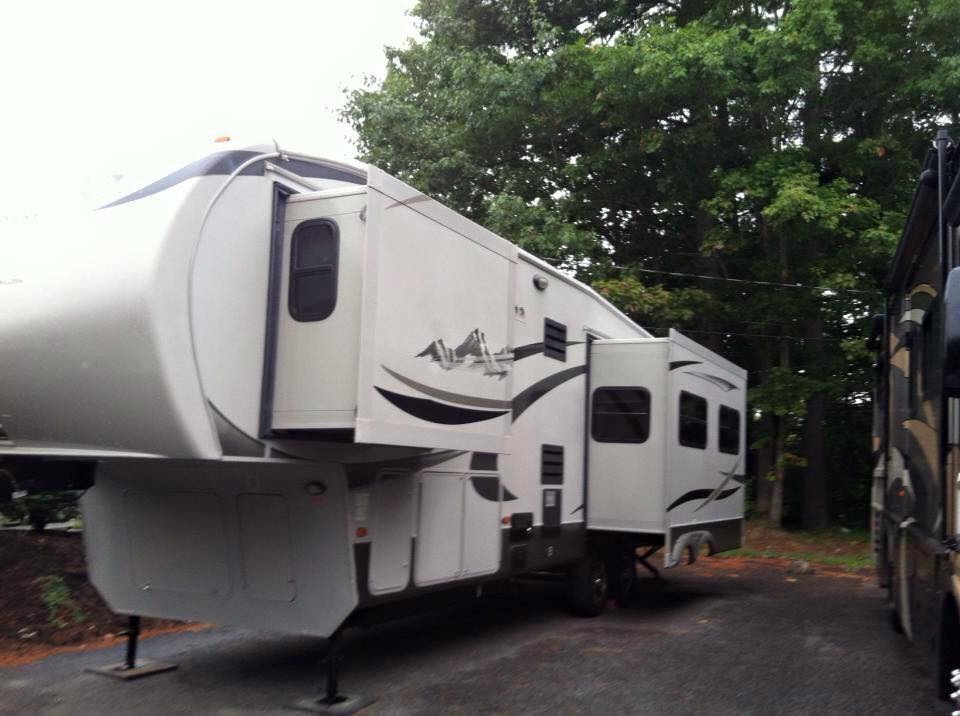 A white rv is parked in a parking lot