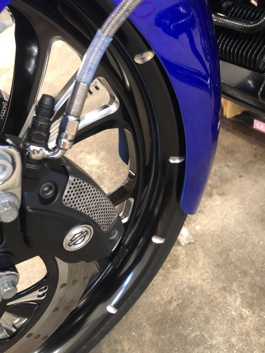 A close up of the front wheel of a motorcycle