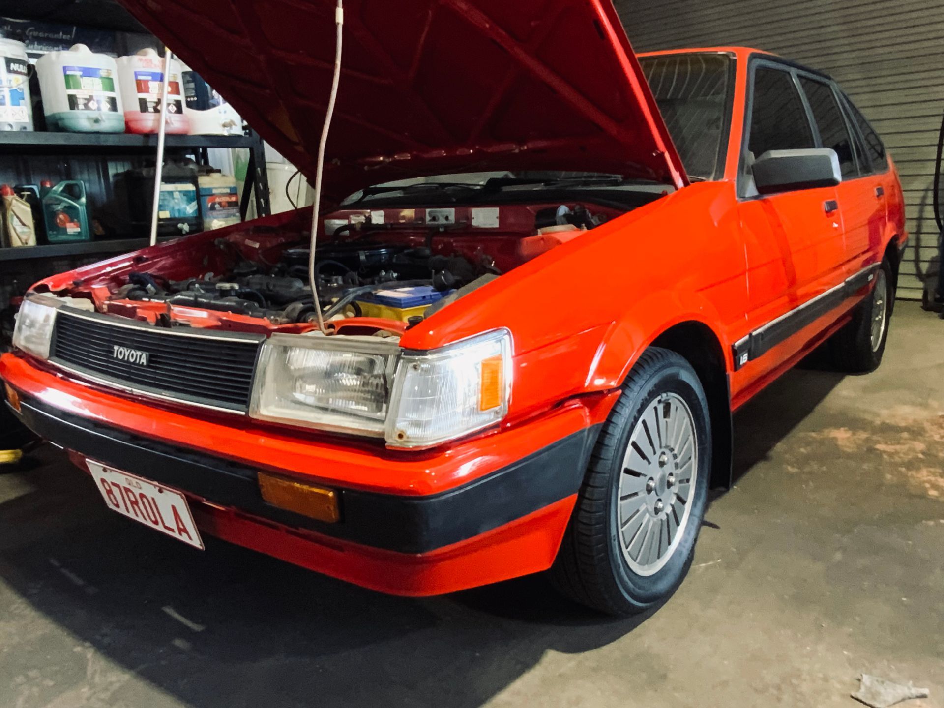 A Car is Sitting on a Lift in a Garage for Checking Suspension — H.M. Mechanical in Gowrie Junction, QLD