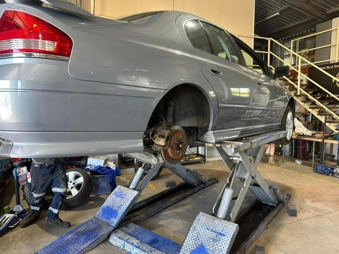 A Car is Sitting on a Lift in a Garage for the Replacement of Brakes — H.M. Mechanical in Drayton, QLD