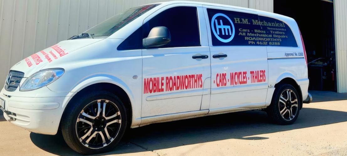 Mobile Roadworthys Van Outside of a Large Shed— H.M. Mechanical in Drayton, QLD