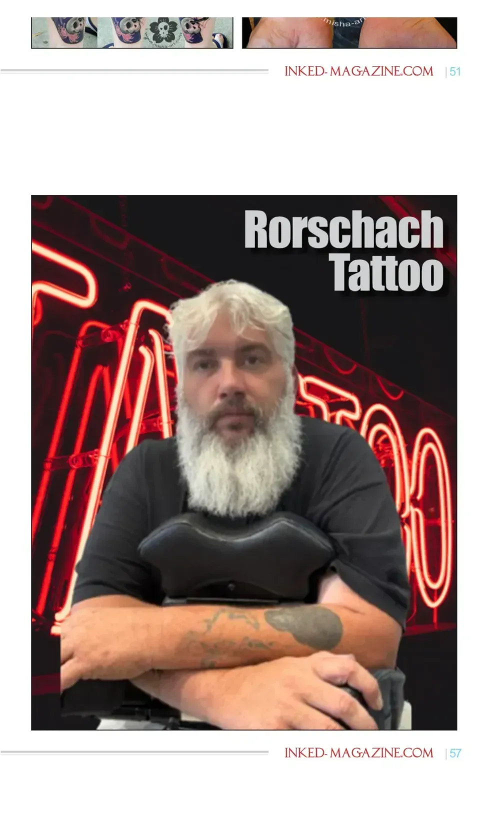 Man with a white beard sits in front of a neon "Tattoo" sign.