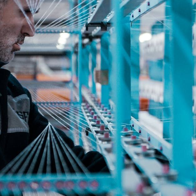 A man is working on a machine in a factory.