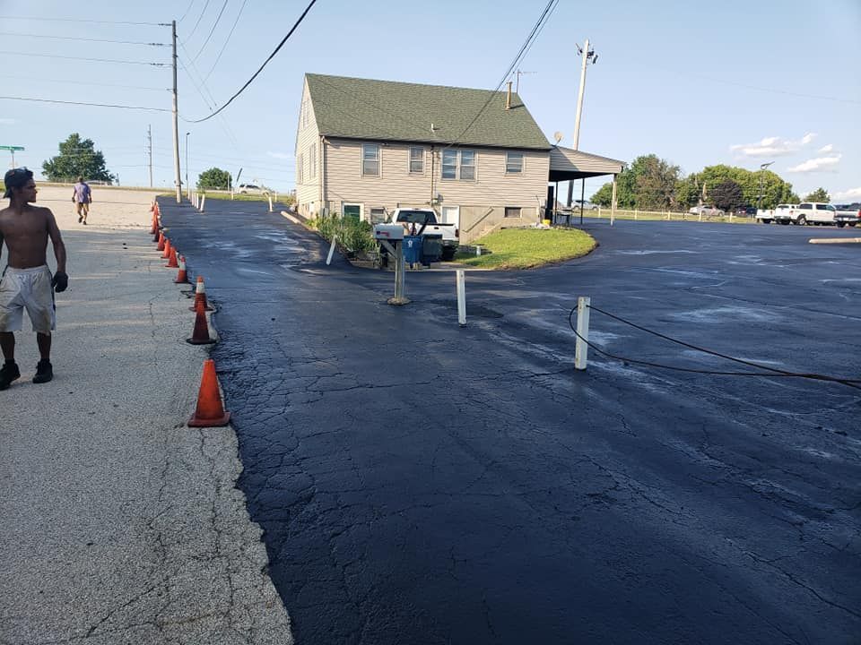 A man is walking down a street next to a building.