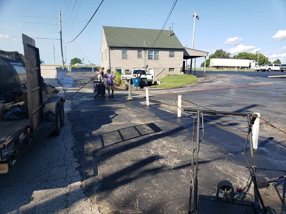 A group of people are walking down a street in front of a building.