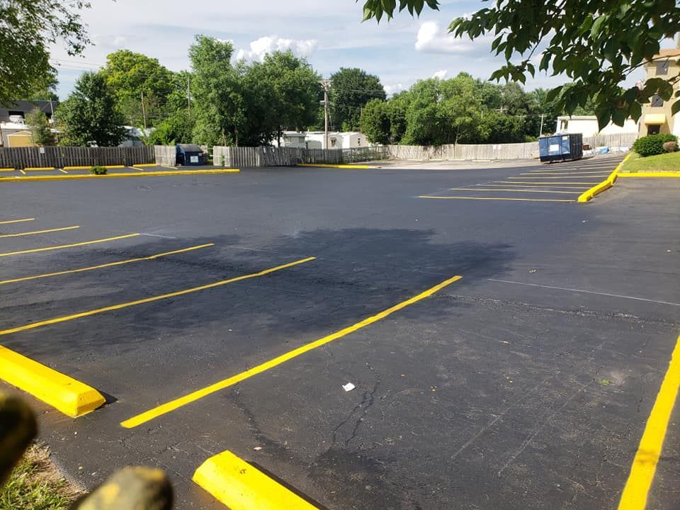 A parking lot with yellow lines and yellow curbs