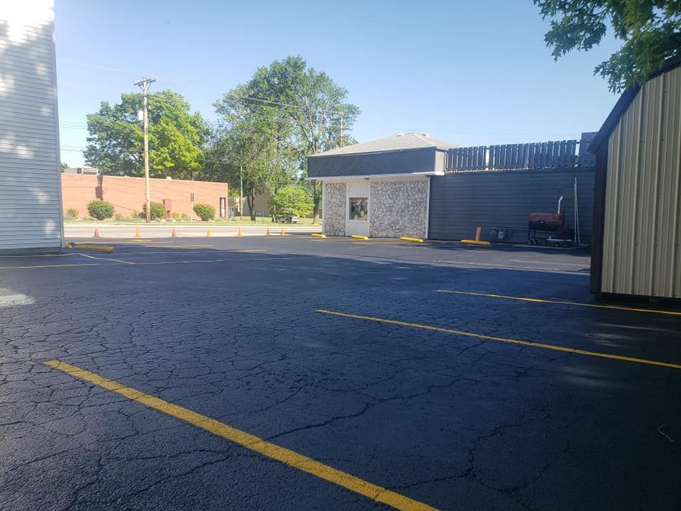 A parking lot with a building in the background.