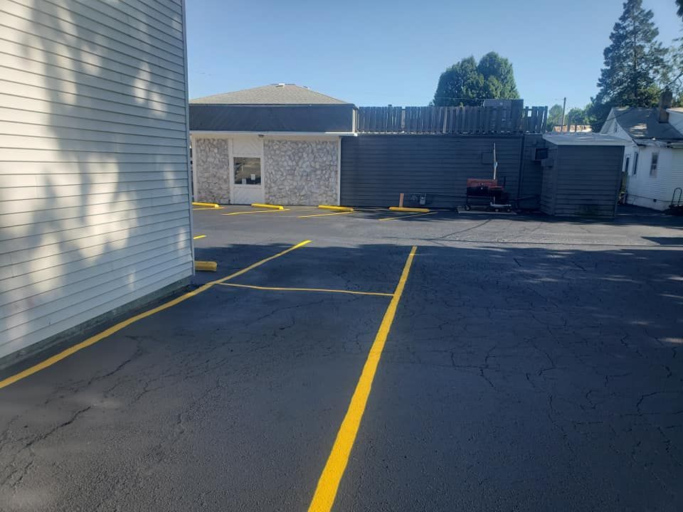 A parking lot with a yellow line between two buildings.