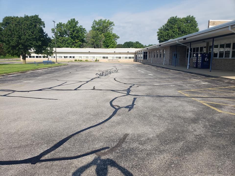 An empty parking lot in front of a building