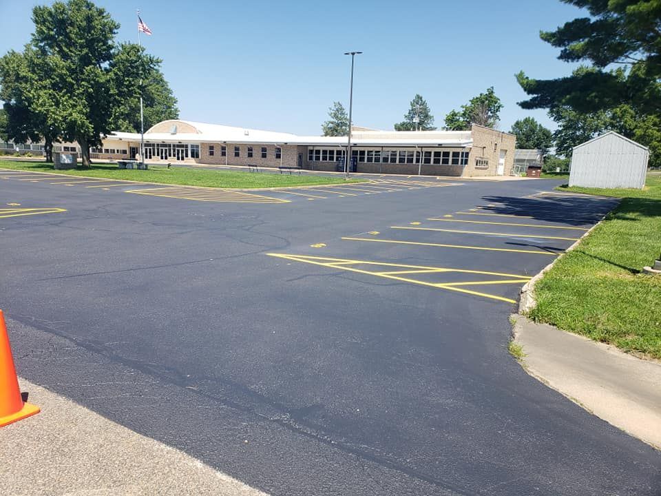 A parking lot with a large building in the background
