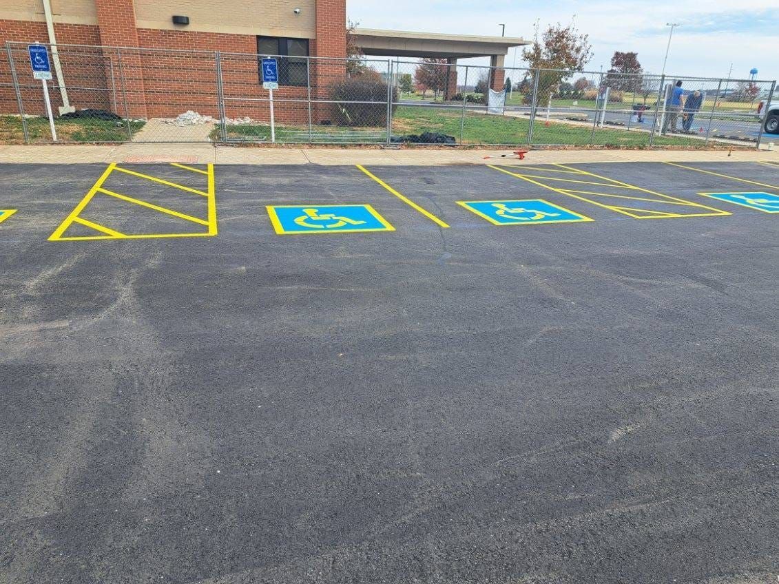 A parking lot with handicapped parking spaces painted on it.