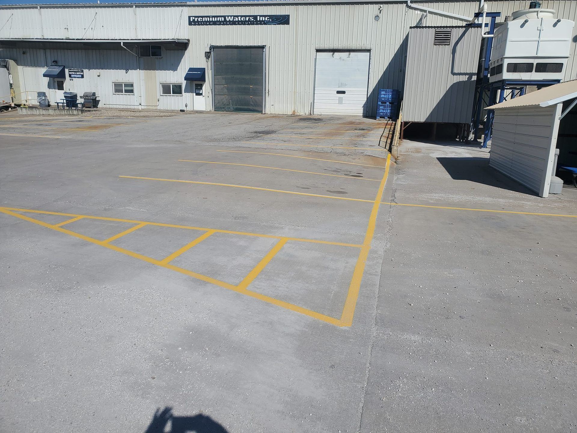 A parking lot with a building in the background