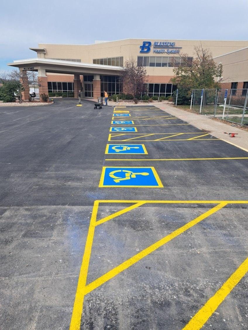 A row of handicapped parking spaces in front of a building