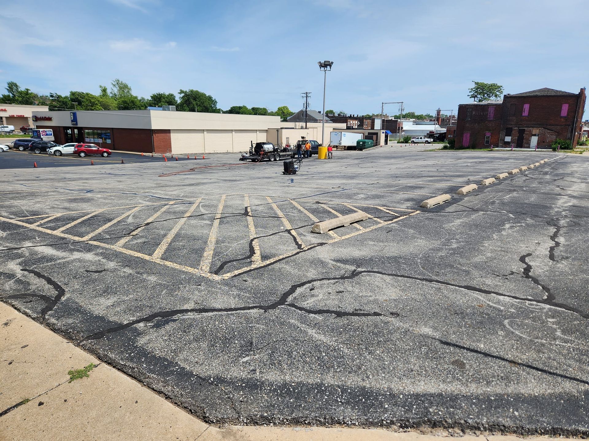 An empty parking lot with a building in the background