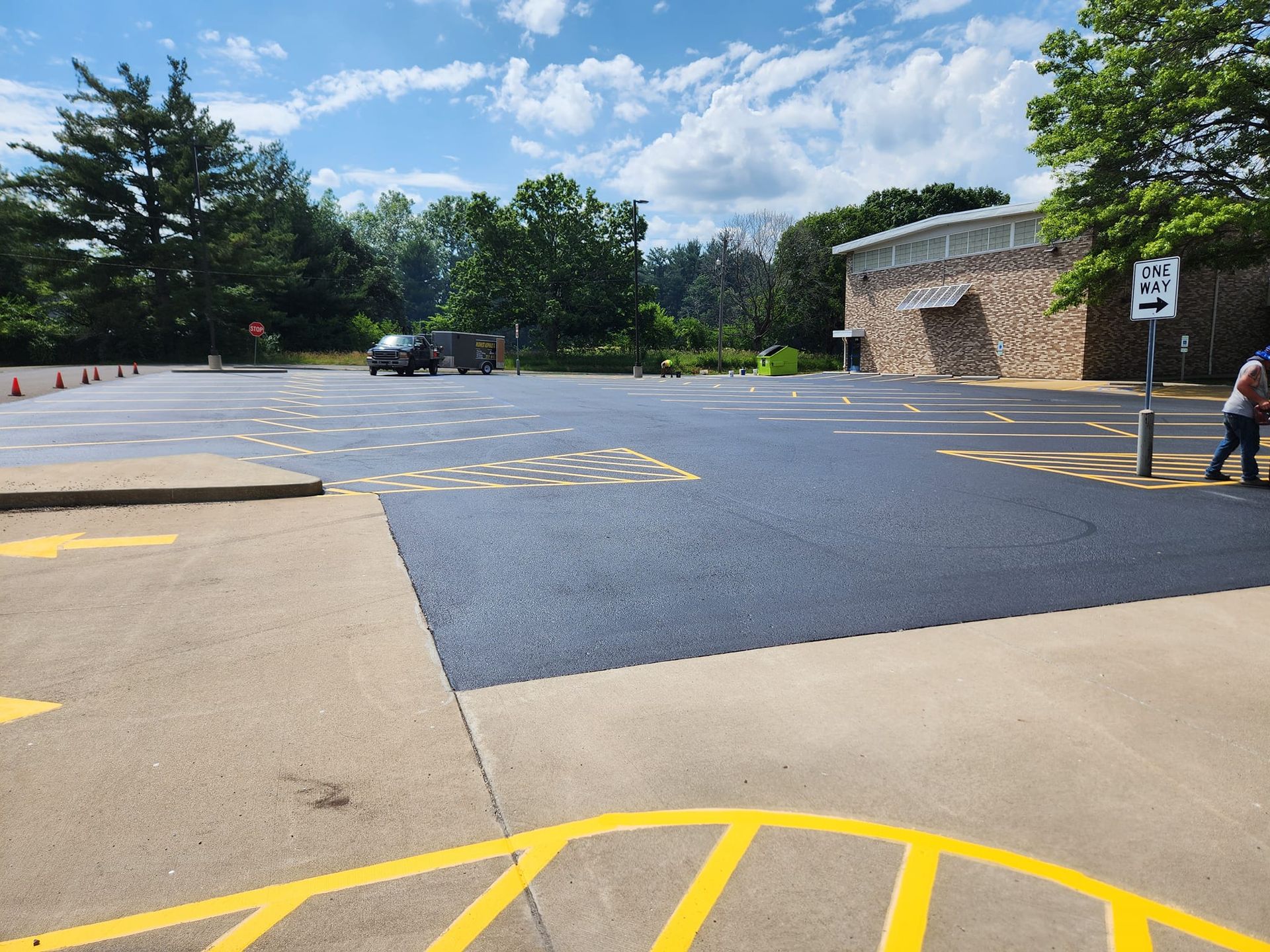A parking lot with a handicap ramp and a sign that says no left turns