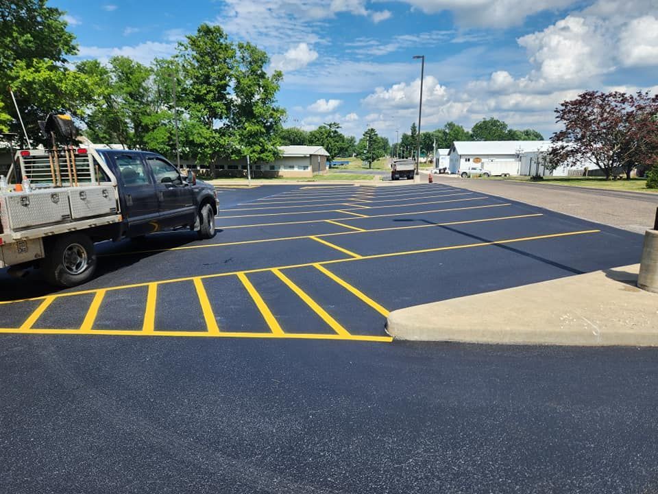 A truck is parked in a parking lot with yellow lines.