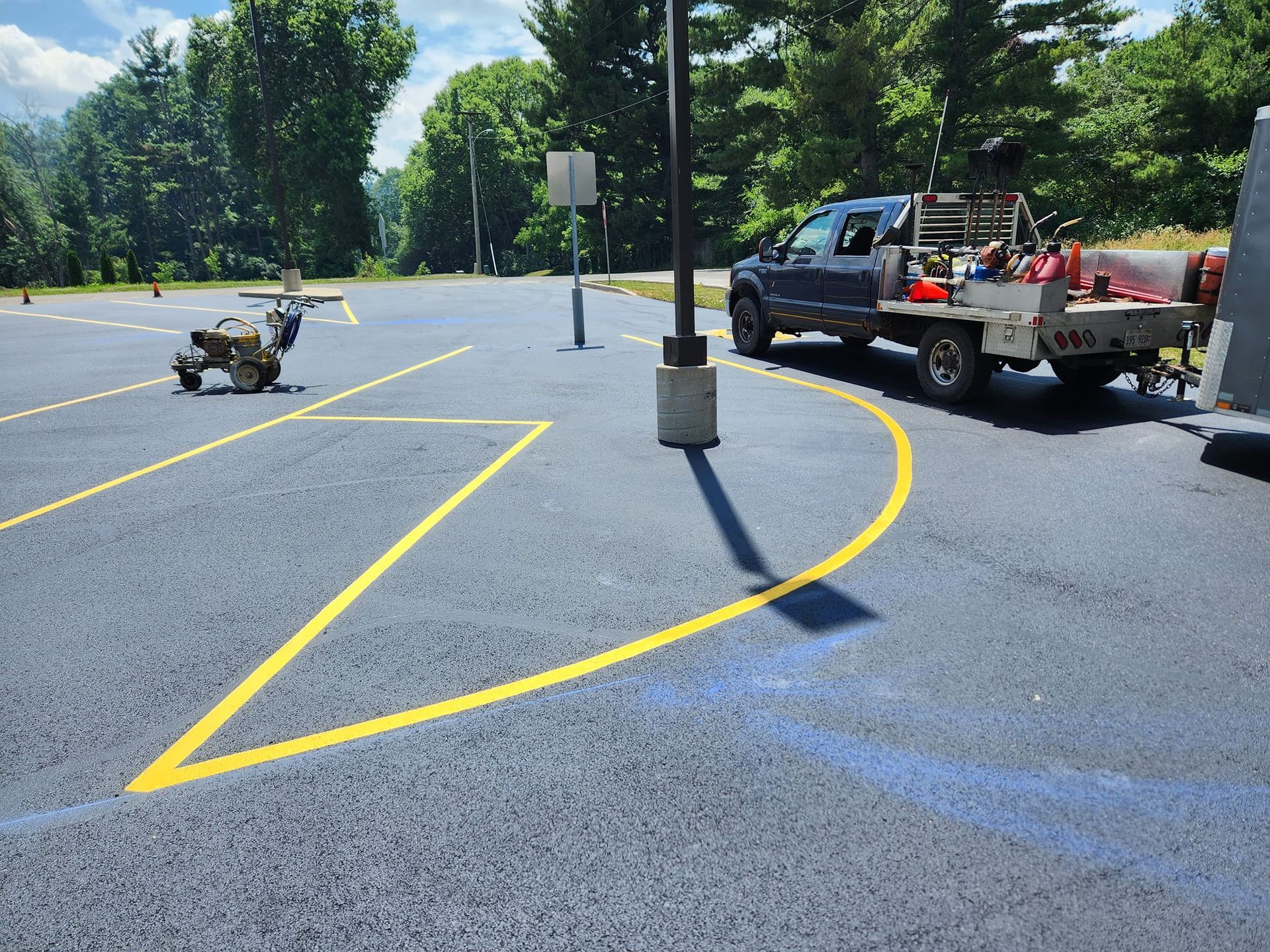 A truck is parked in a parking lot next to a yellow line