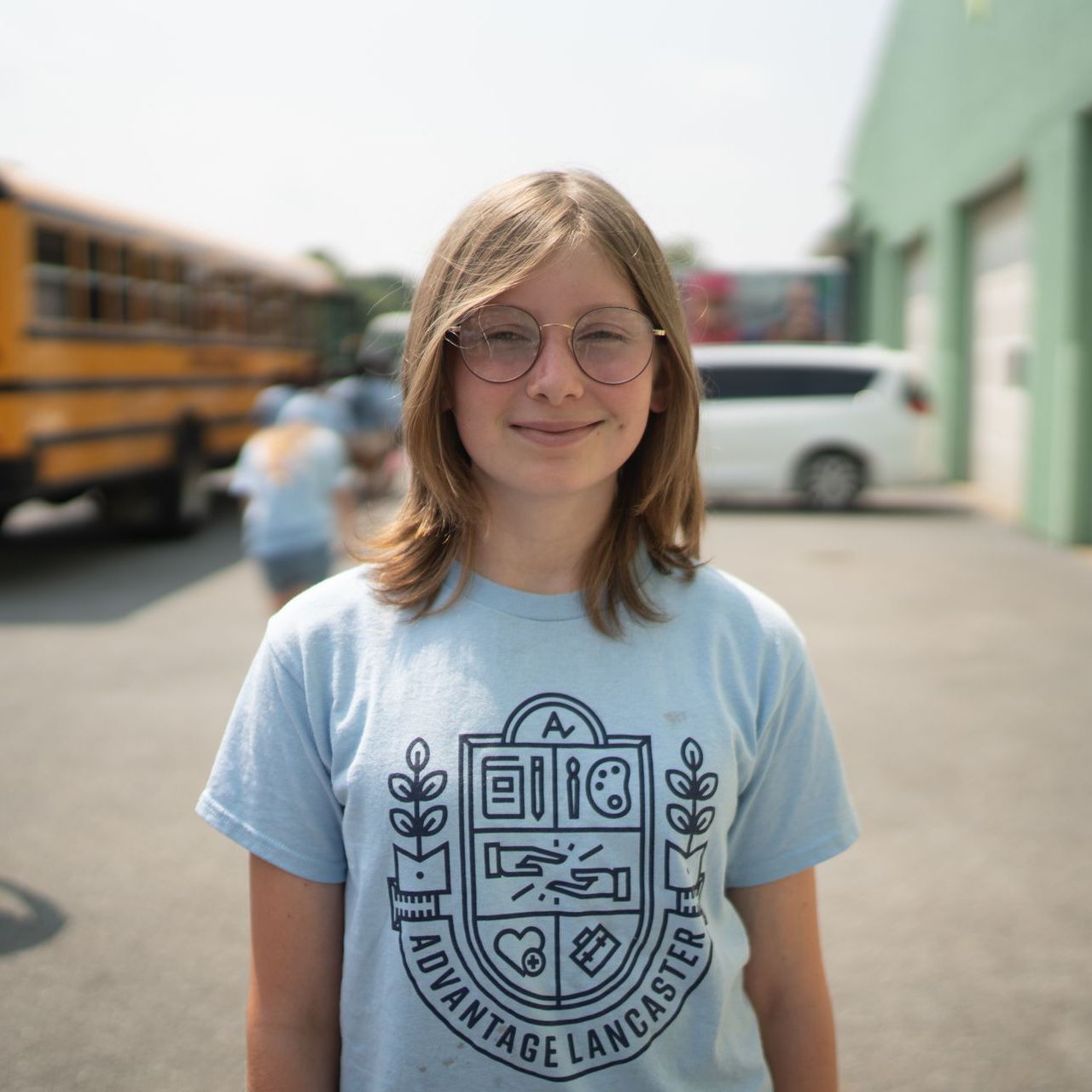 A girl wearing a blue shirt that says advantage lancaster