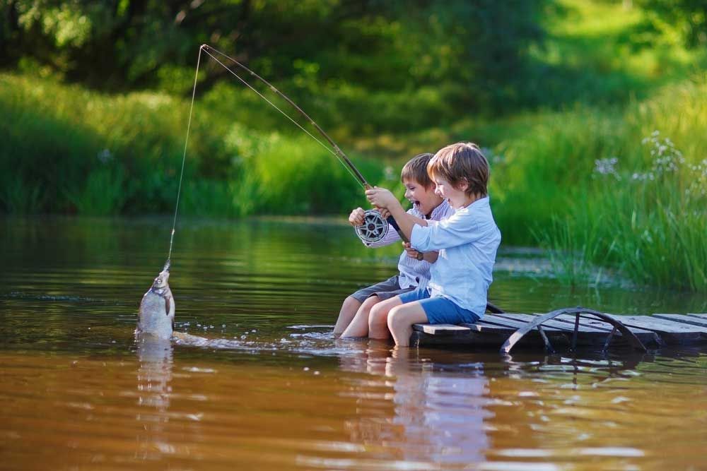 Laughing boys fishing at Lake Ozark, Steve's Pest Control